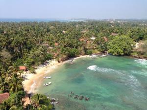 view from lighthouse onto a tropical beach sri lanka