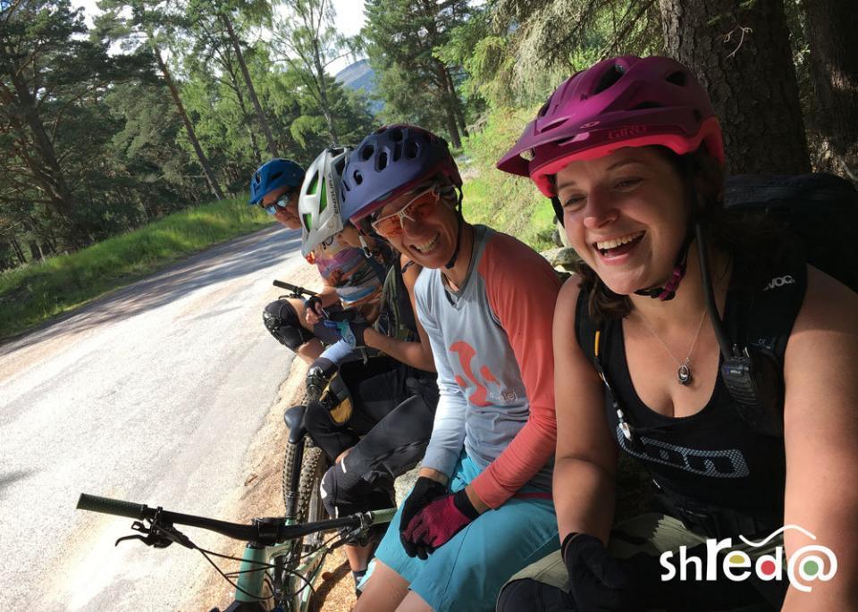 group of female mountain bikers laughing