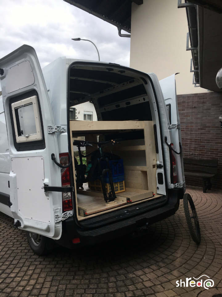 raw van build with bed and heavy duty racks