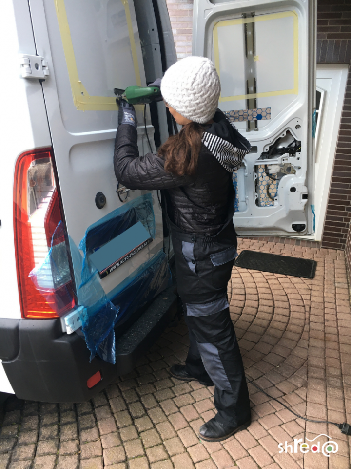 cutting holes into the van for the rear windows