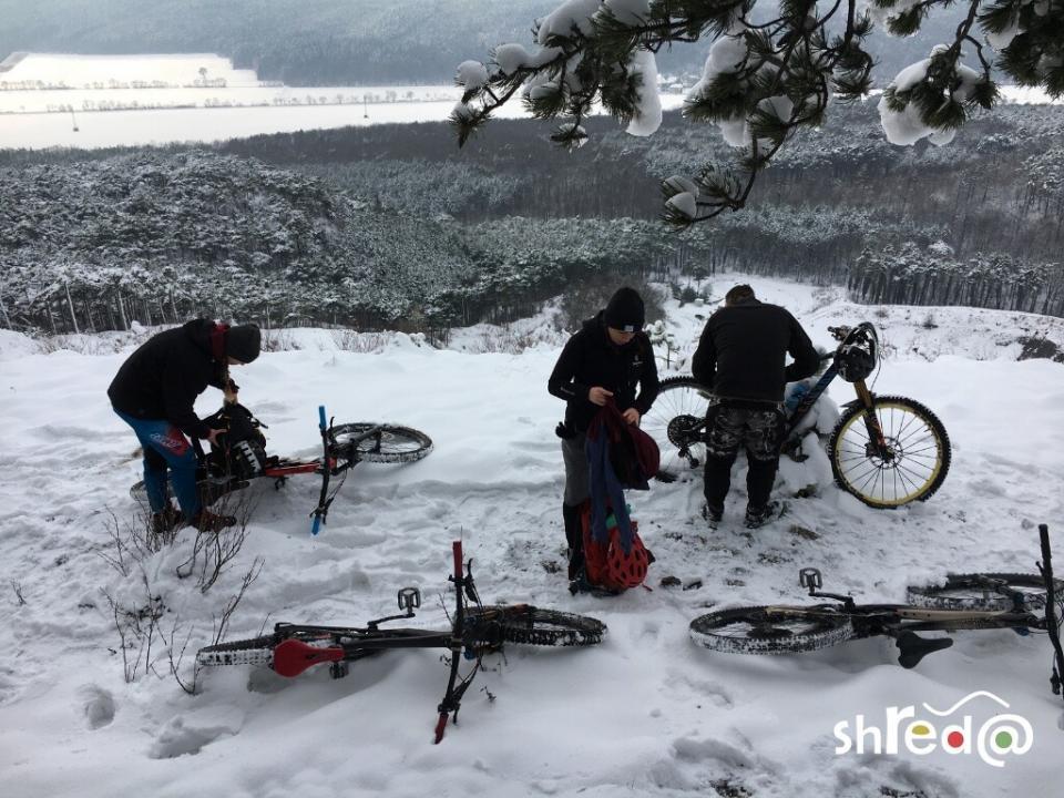 group of mountain bikers in the snow